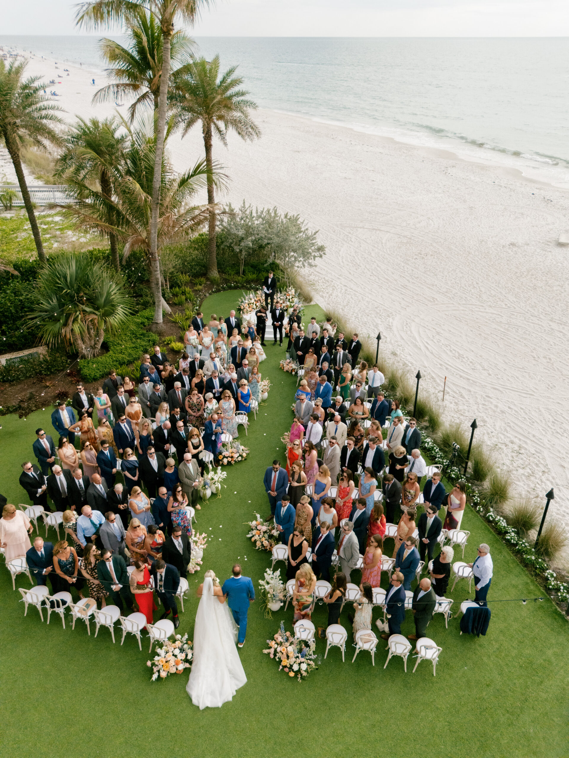 Bride and father walking down the aisle in the Lawn at LaPlaya Beach Resort in Naples