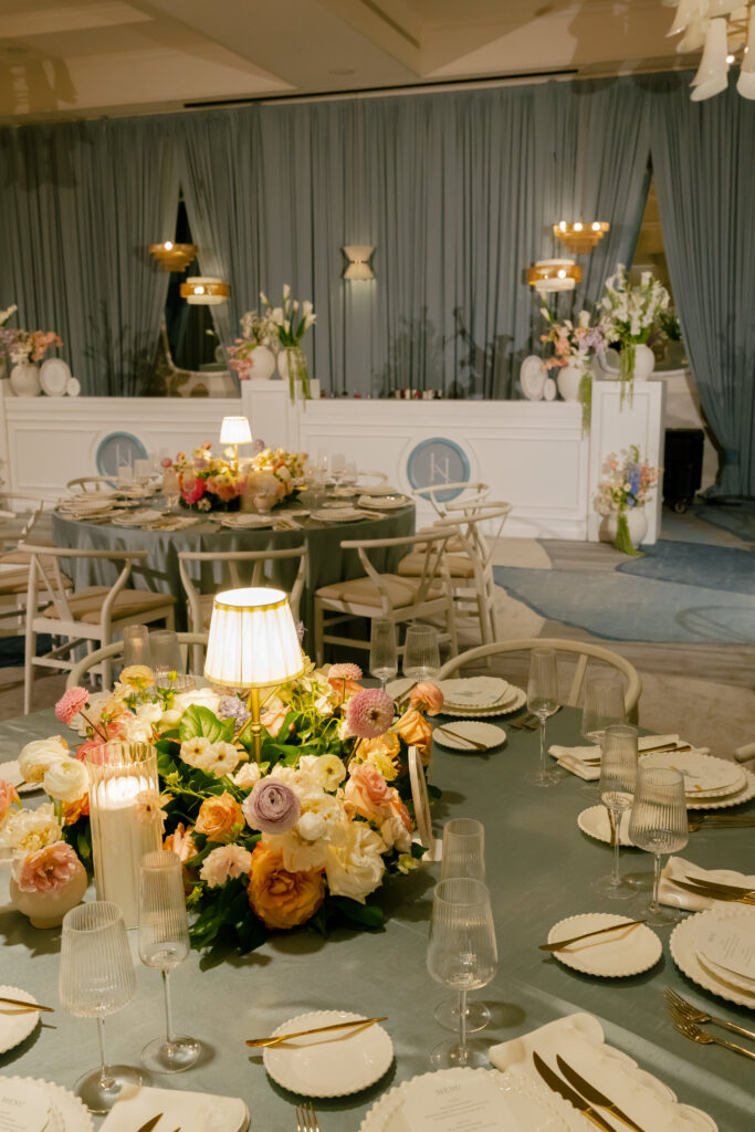 Wedding Reception draped in Blue with white bar and cascading florals.